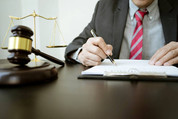 The lawyer was holding a pen to write legal documents stock photo