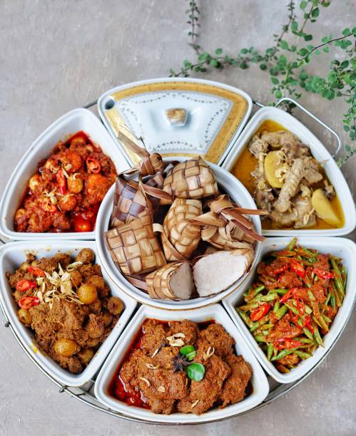 The Lebaran dishes. Ketupat Sayuran special in Lebaran, served with Rendang, Chicken Opor, Sambal Goreng Chickpeas. Special dishes during Eid al-Fitr and Eid al-Adha, especially in Indonesia. eid al adha stock pictures, royalty-free photos & images