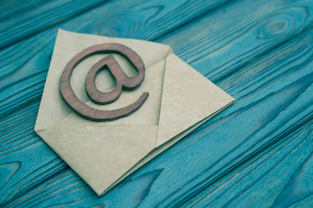 the letter, sign the e-mail on a wooden background stock photo
