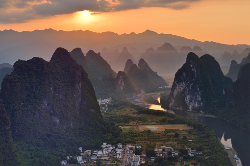 Asia,China,Guilin,Yangshuo,Xingping,Xianggong hill.\nYangshuo is a world famous tourist resort.\nYangshuo is a county of guilin prefecture.\nGuilin karst has been included in the world heritage list.\nHere the Li River snakes through a fairy-tale landscape of conical limestone peaks,its smooth waters exquisitely mirroring the magical.\nStand at the top of the hill to see the Lijiang River,\nLijiang River and its tributaries,the shuttle in the \nShiShanfeng forest,mountains and water and hold,very beautiful.\nBeautiful Lijiang River,is the world's largest and most beautiful karst landscape scenic resort.\nIt's the most beautiful landscape waterway has about 15 km.\nLarge numbers of tourists visit the Li river by yachts every year.