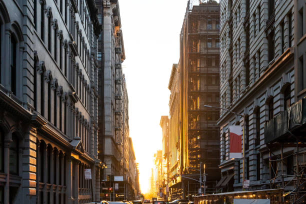 The light of summer sunset shines between the buildings on 19th Street in New York City stock photo