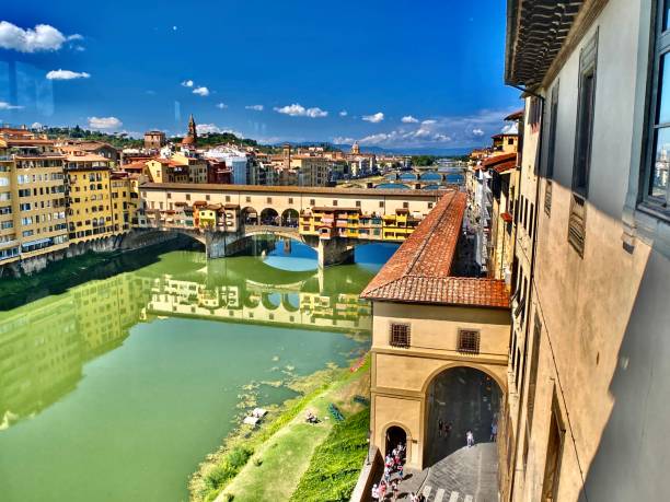 the lofted view of the ponte vecchio and the reflections of the arno river. stock photo