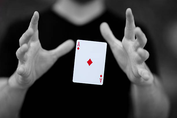 The Magic Number Magician levitating a card magically though mid-air magician stock pictures, royalty-free photos & images