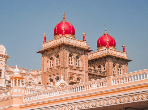 The majestic Mysore Palace known also as Ambavilas Palace against a dramatic sunset sky, in Mysuru, Karnataka, South India.