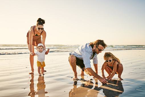 Shot of a happy young family enjoying a day at the beach