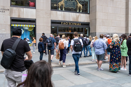 Manhattan, New York City - June 1, 2022 - Crowd of people on hold the FAO schwarz opening in the morning
