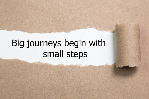 The motivational quote Big journeys begin with small steps stock photo