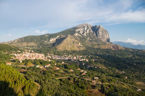 The mountain range of Monte Bulgheria and the township of San Giovanni a Piro in Cilento in afternoon sunlight, Campania, Italy stock photo