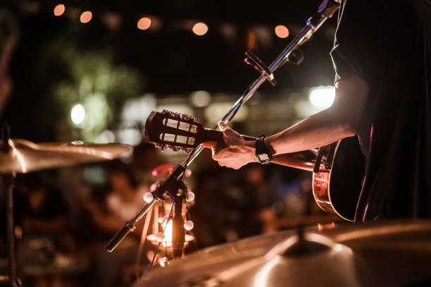 the musicians were playing rock music on stage, there was an audience full of people watching the concert. concert,mini concert and music festivals. - concert imagens e fotografias de stock