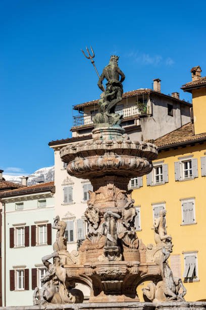 The Neptune fountain in Cathedral square - Trento Italy The Neptune fountain in Cathedral square (Piazza del Duomo) with the bronze statue of the Roman God with the trident. Trento downtown, Trentino-Alto Adige, Italy, Europe poseidon statue stock pictures, royalty-free photos & images