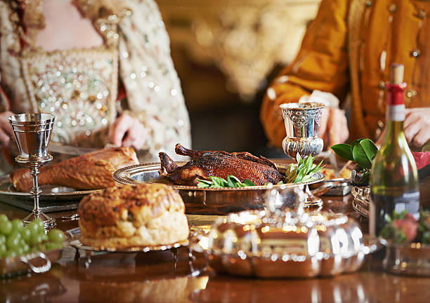 The nobility feasts while the people hunger stock photo