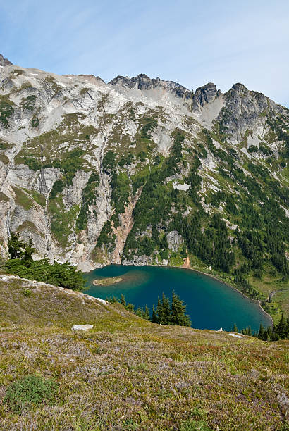 Doubtful Lake and Sahale Mountain The North Cascades is a vast wilderness of conifer-clad mountains, glaciers and lakes. It is one of the more remote wilderness areas in the Continental United States. This view of Doubtful Lake was photographed from Sahale Arm in North Cascades National Park near Marblemount, Washington State, USA. jeff goulden north cascades national park stock pictures, royalty-free photos & images