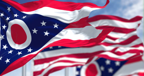 The Ohio state flag waving along with the national flag of the United States of America stock photo