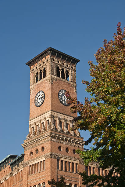 Old Tacoma City Hall Clock Tower The Old City Hall, built in 1893, is a five-story building in the Italianate architecture style that served as the city hall for Tacoma in the early 20th century. The building features a ten-story clocktower on the southeast corner. It was added to the National Register of Historic Places on May 17, 1974. Old City Hall is in Tacoma, Washington State, USA. jeff goulden government building stock pictures, royalty-free photos & images