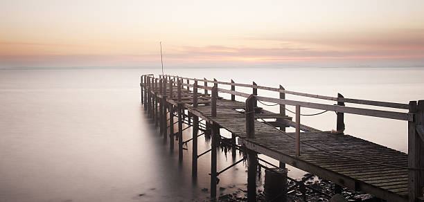 The Old Pier Old disused pier on Strangford Lough, Co. Down, Northern Ireland at sunset strangford lough stock pictures, royalty-free photos & images