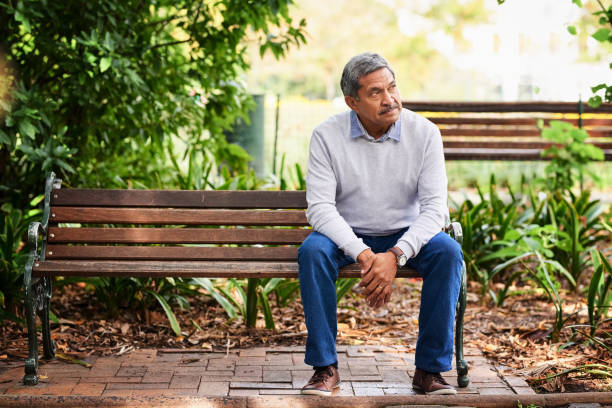 The park is where he comes to ponder a while Shot of a mature man looking thoughtful outdoors park bench stock pictures, royalty-free photos & images