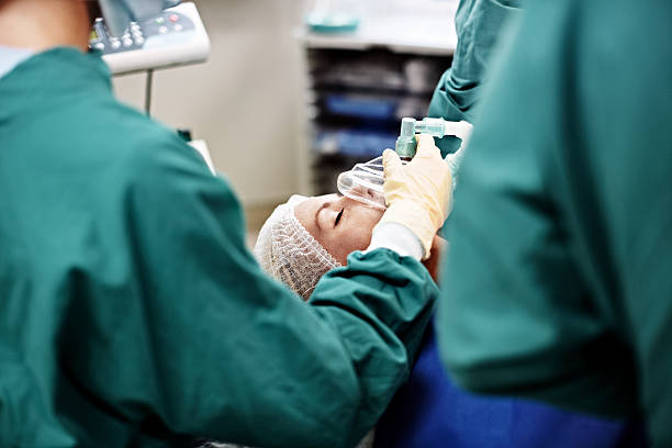 The patient is responding well to the anesthesia Shot of an anesthesiologist and surgeons working on a patient in an operating room anesthetic stock pictures, royalty-free photos & images