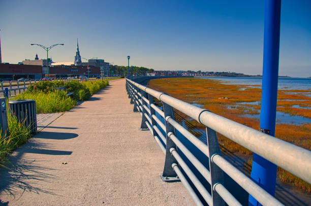 The pedestrian sidewalk that runs along the St. Lawrence River. stock photo