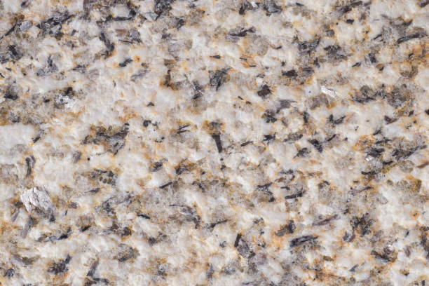 The phaneritic texture of a granite (common intrusive igneous rock) with visible mineral grains stock photo