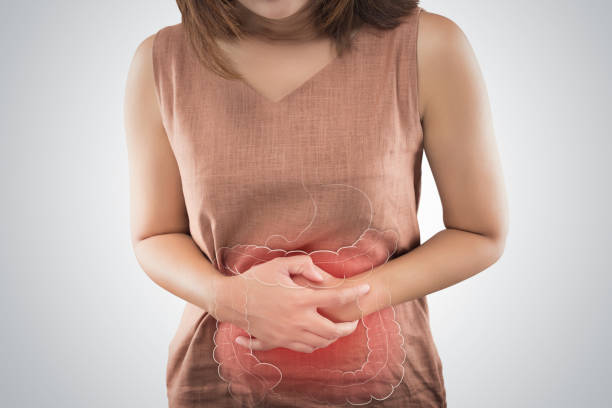 the photo of large intestine is on the woman's body. people with stomach ache problem concept. female anatomy - beleza doentes cancro imagens e fotografias de stock
