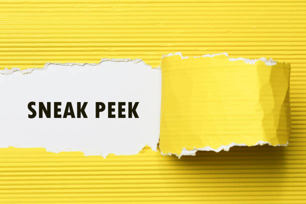 The phrase Sneak Peek appearing behind torn yellow paper. stock photo