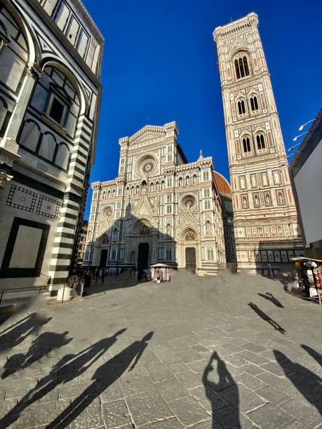 the piazza del duomo; giotto’s campanile (bell tower) beside the cattedrale di santa maria del fiore (florence cathedral). stock photo