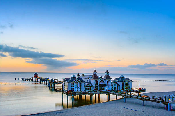 The pier of Sellin at dusk The pier of Sellin at the Baltic Sea at dusk sellin stock pictures, royalty-free photos & images