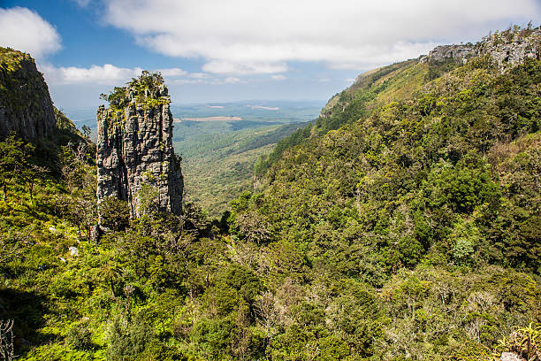 The Pinnacle Rock amid lush tropical vegetation stock photo