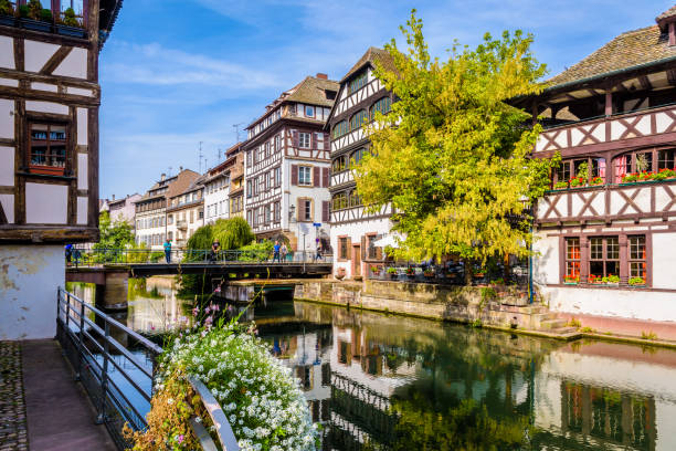 The Pont du Faisan in the Petite France historic quarter in Strasbourg, France. Strasbourg, France - September 14, 2019: The Pont du Faisan in the Petite France quarter, a medieval district on the river Ill lined with typical half-timbered houses by a sunny summer day. petite france strasbourg stock pictures, royalty-free photos & images