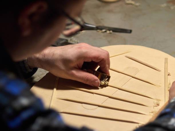 The process of making a classical guitar. Making the right shape of a brace guitar. stock photo