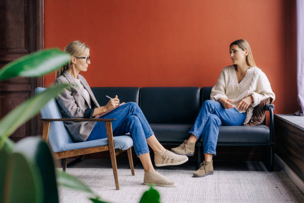 The psychotherapist interviews and consults the patient during the session. stock photo