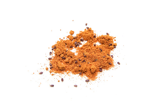 The red curry powder infested with food beetles. A detail od the parasites inside the spice.