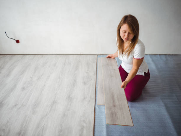 The repair process in the apartment. Girl holding a laminate board stock photo