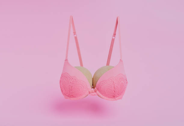 The right support makes all the difference Studio shot of melons in a bra against a pink background bra stock pictures, royalty-free photos & images