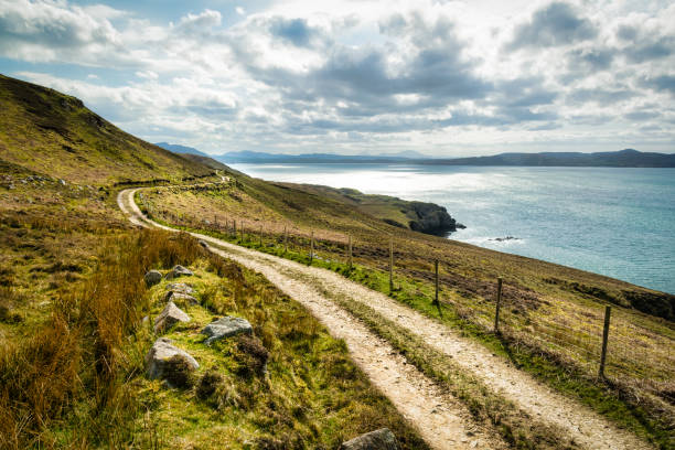The Road to No Where A rural dirt road that goes up to the Urris mountains in Donegal Ireland.  It is situated next to the sea. inishowen peninsula stock pictures, royalty-free photos & images