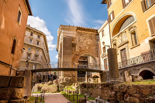 The remains of the Roman temple of the Portico D'Ottavia in the ancient Jewish Ghetto, in the historic heart of the Eternal City. According to tradition, the fish market was held in this place in ancient Rome. The iconic Jewish Quarter of Rome, the oldest ghetto in Europe, is famous for the presence of hidden alleys and small squares, where it is easy to find small restaurants of Italian and Jewish cuisine, and remarkable Roman archaeological remains. The ghetto of Rome is located in one of the oldest districts of the Eternal City, located between the Capitoline Hill or Campidoglio (Roman Capitol) and the Tiber river. In 1980 the historic center of Rome was declared a World Heritage Site by Unesco. Super wide angle and high definition image.