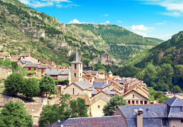 The roofs of Sainte-Enimie.Occitanie.France. On the slopes of a canyon dug by the Tarn gorges, Sainte-Enimie spreads its massive limestone houses at the foot of an old Benedictine monastery which remains a chapel and a chapter house. gorges du tarn stock pictures, royalty-free photos & images