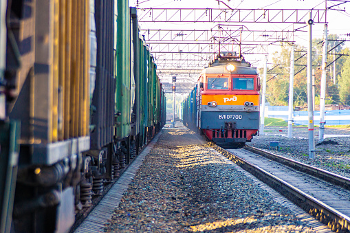 Kemerovo, Russia 27 august 2019. The Russian Railways train travels along a standing freight train