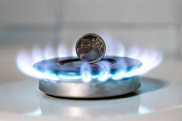 The sale of gas. Increase in the price of gas. The concept of problems in the Russian economy. The ruble is burning on a gas stove. Expensive gas supply stock photo
