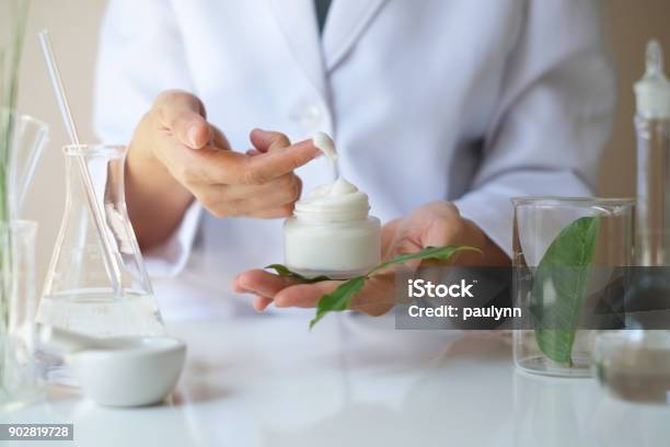 the scientist,dermatologist testing the organic natural product in the laboratory.research and development beauty skincare concept.blank package,bottle,container .cream,serum.