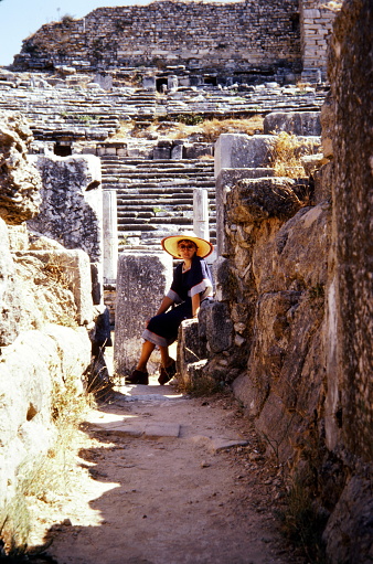 Turkey, June 1974.  A young woman with sun hat at the DidymaTemple of Apollo.