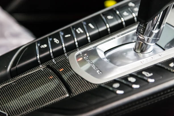 The shift knob of the full-size luxury car Porsche Panamera Turbo. Carbon panel with logo, shiftgear PDK stock photo