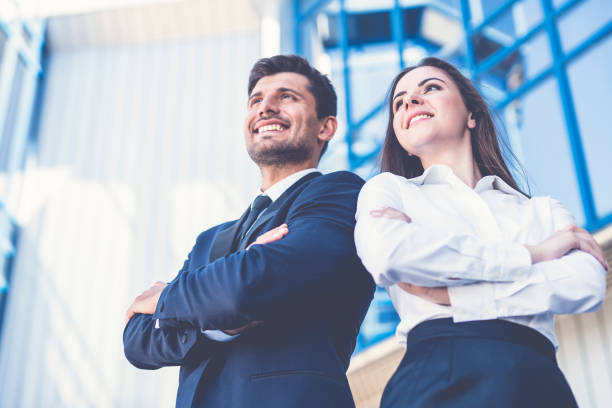 The smile man and woman stand on the background of the office center stock photo