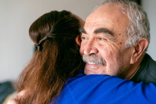 The smiling old father who longingly hugs his daughter The smiling old father who longingly hugs his daughter fathers day stock pictures, royalty-free photos & images