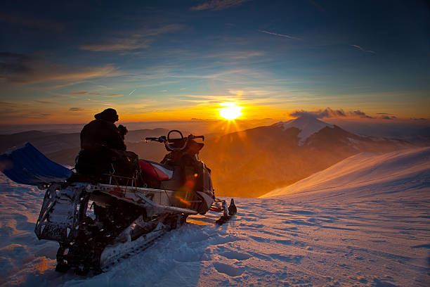 the snowmobile on a beautiful winter landscape - scooter stockfoto's en -beelden