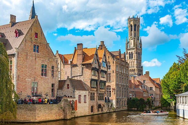 The Spanish House in Brugge Belgium, Brugue - September 26, 2015: The Spanish House and canal seen from Rozenhoedkaai with the Belfry at the rear and tourists taking a boat ride Bruges, Belgium, Western Europe. brugge, belgium stock pictures, royalty-free photos & images