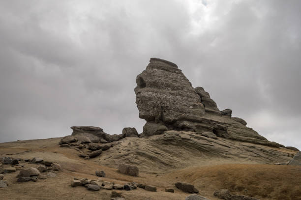The Sphinx from Bucegi Mountains with Dramatic Clouds Natural formation rock Sphinx from Bucegi. bucegi mountains stock pictures, royalty-free photos & images