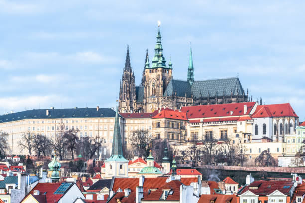 The spires and rooftops of Prague Vysehrad The spires of the St. Vitus Cathedral among the picturesque tile roofs of the old quarter of Prague. hradcany castle stock pictures, royalty-free photos & images