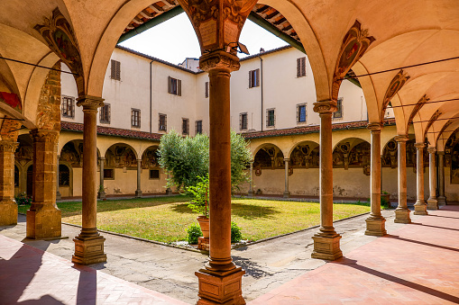 The splendid cloister of the Franciscan convent of San Salvatore in Ognissanti, or simply Chiesa di Ognissanti (Church of All Saints), in the historic heart of Florence. Inside the church, built starting from 1251 and completed in 1637 in Baroque style, there are some artistic masterpieces by Giotto, Domenico Ghirlandaio and Sandro Botticelli. In this church there is the tomb of Sandro Botticelli. Since 1982 the historic center of Florence has been declared a World Heritage Site by Unesco. Image in high definition format.