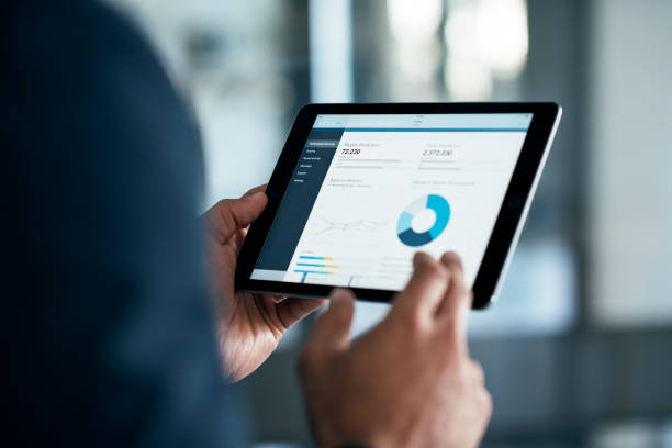 The stats have a lot to say Closeup shot of a businessman analyzing statistics on a digital tablet in an office device screen stock pictures, royalty-free photos & images